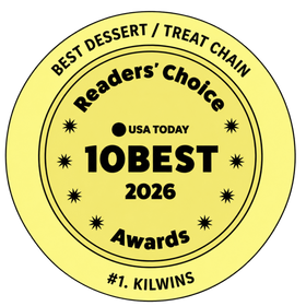 A round yellow badge with black text reading 'Best Dessert / Treat Chain', 'Readers' Choice', '10Best Awards 2026', and '#1. Kilwins'.