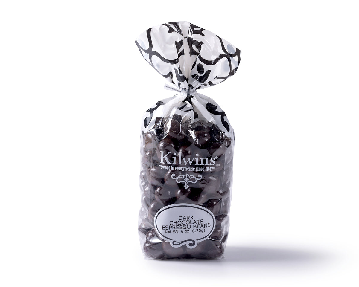 Kilwins Dark Chocolate Espresso beans in a clear bag, on a solid white background.