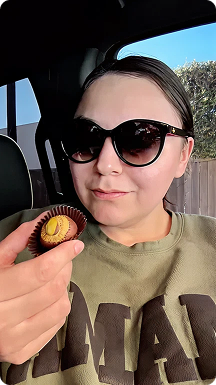 Woman in sunglasses holding a Kilwins Dubai chocolate