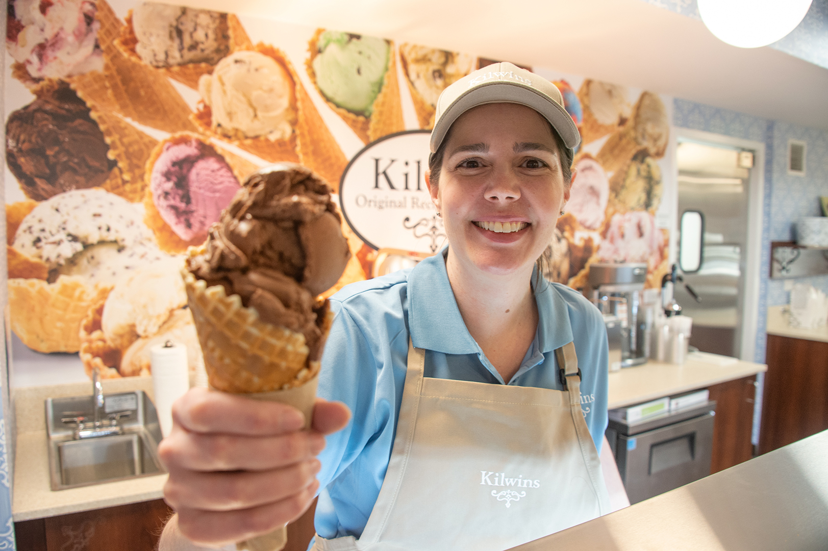 Picture of the owner of the Arlington Heights store with an ice cream cone