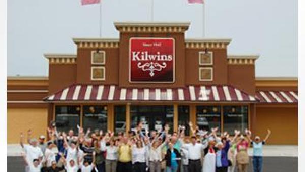 The Kilwins team members wave to the camera outside of the Kilwins store
