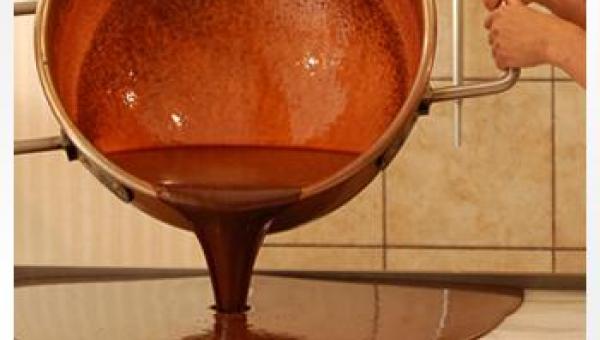 Pouring Fudge Out of a Large Copper Kettle