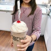 Little girl holding milkshake