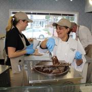 Picture of employees preparing treats dipped in chocolate