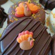 Photo of Chocolate-covered cookies with Thanksgiving turkey icing topper decorations