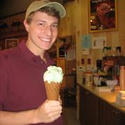 Photo of male employee in store holding Ice Cream in a Waffle Cone