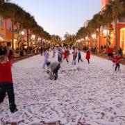 People playing in snow in street in Celebration, FL