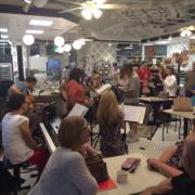 Photo of customers listening to band play inside Kilwins Geneva store